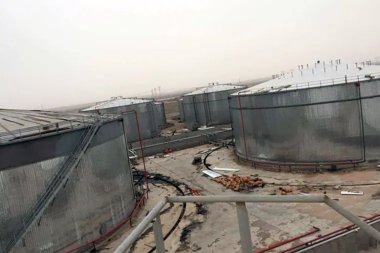 Tanks clad in corrugated metal sheeting in a tank farm, seen from above