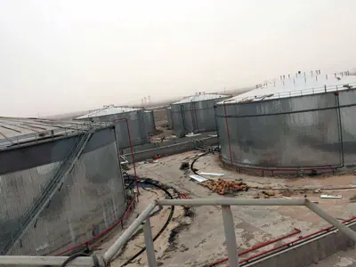 Tanks clad in corrugated metal sheeting in a tank farm, seen from above