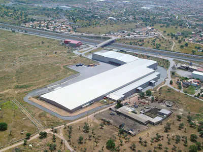 Warehouse with a row of loading docks, aerial view over scrubland