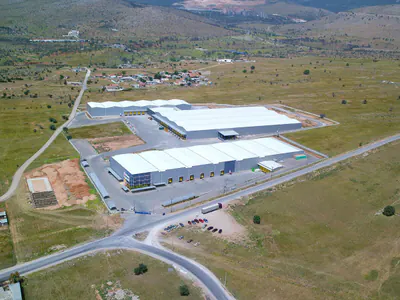 Warehouse complex beside a road junction, aerial view