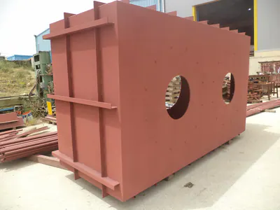 Large red-primed steel duct section with two round openings