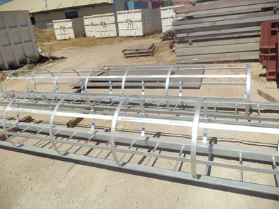 Galvanised steel caged ladders laid on the ground