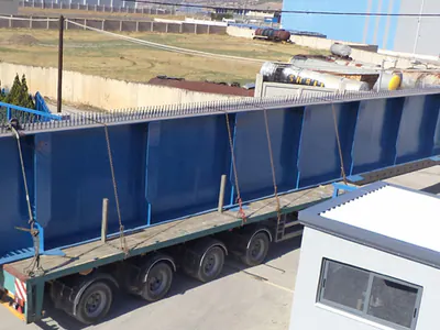 Blue steel bridge girder on a lorry trailer