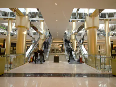 Atrium with twin escalators between gold-coloured columns