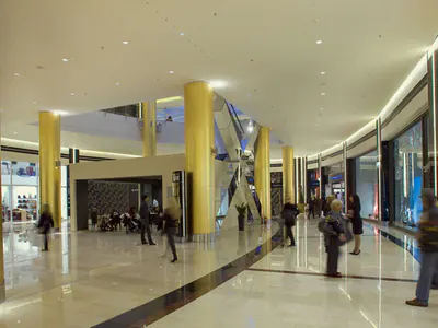 Concourse lined with shops and gold-coloured columns