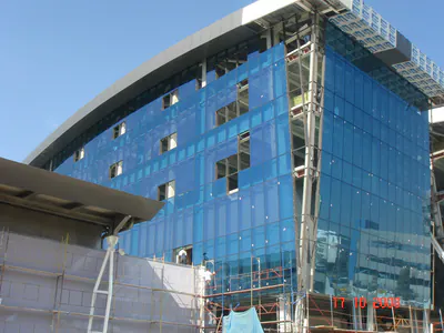 Blue glass curtain wall of a multi-storey building