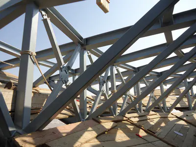 Grey steel trusses with bolted joints, close up