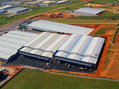 Warehouse complex with loading docks among fields, from the air