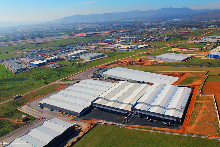 Warehouse complex in an industrial area, mountains in the distance