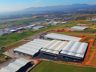 Warehouse complex in an industrial area, mountains in the distance