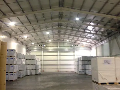 Warehouse interior with pallets of goods along the walls