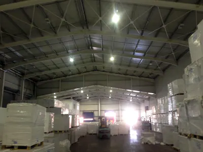 Stocked warehouse under a steel portal-frame roof