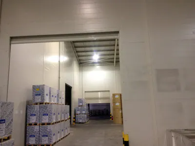 Opening between warehouse halls, with pallets of boxes