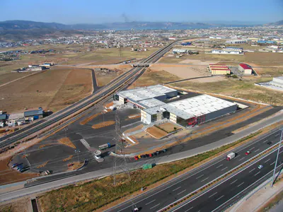 Warehouse and office complex beside a motorway, from the air