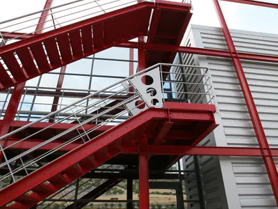 Red steel stair flights and landings seen from below