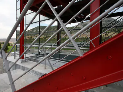Red steel stair stringer and handrails, close up