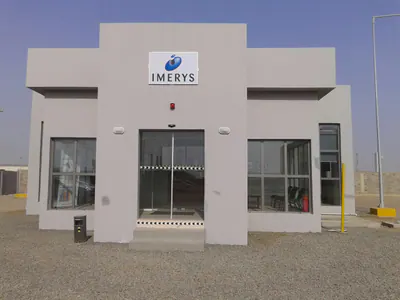 Small single-storey building with the Imerys logo over its glazed entrance