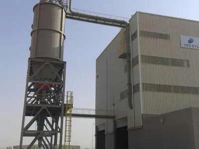 Steel silo tower linked to a clad industrial building