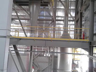 Tall steel process vessels and platforms inside a plant