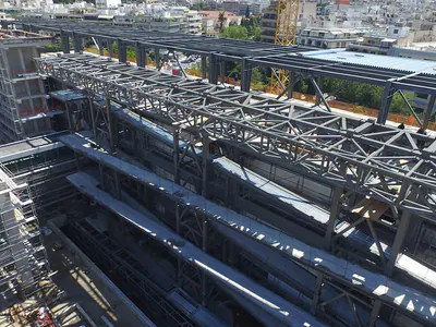 Steel roof trusses spanning a building under construction, aerial view