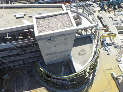 Roof of a building core with curved steel framing below, from above