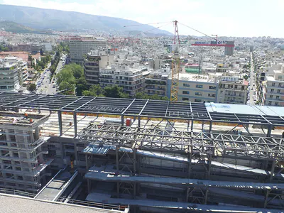 Steel roof framework over a building, the city spreading behind