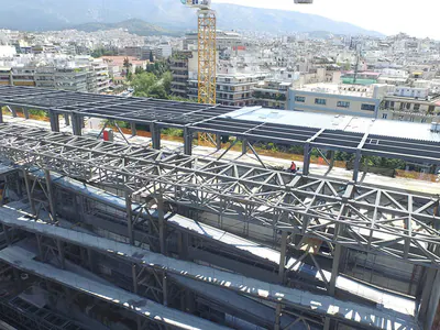 Roof trusses with decking over a building, the city and mountains behind