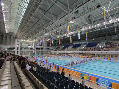 Swimming pool hall during a competition, spectators in the stands