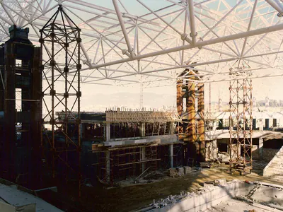 Temporary support towers under a steel space-frame roof during erection