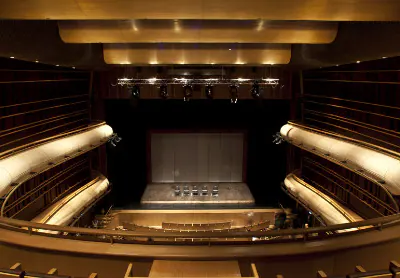 Auditorium with curved balconies and a lit stage
