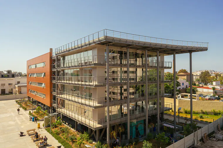 Multi-storey building with an exposed steel frame, balconies and a roof canopy