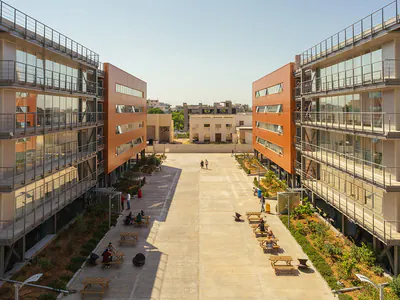 Two multi-storey buildings facing each other across a paved courtyard