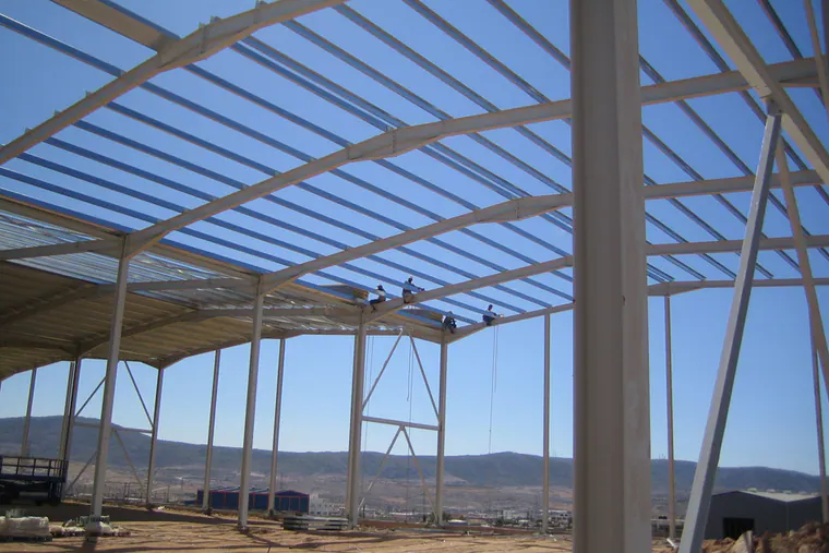 Steel roof frame of a building under construction, seen from inside
