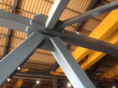 Crossing members of a steel truss under a workshop roof