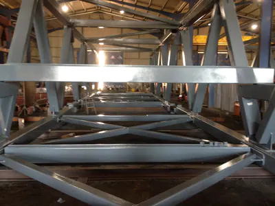 View along the inside of a steel truss in a workshop