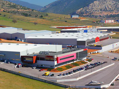 Office and warehouse complex among industrial buildings, aerial view