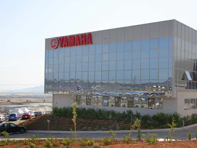 Glass-fronted office block with the Yamaha sign on its facade
