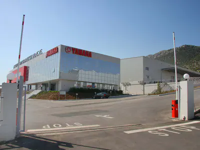 Entrance gate and barrier in front of a glazed office building