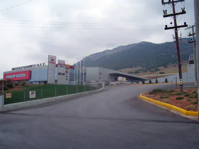 Access road to an office and warehouse complex, mountains behind